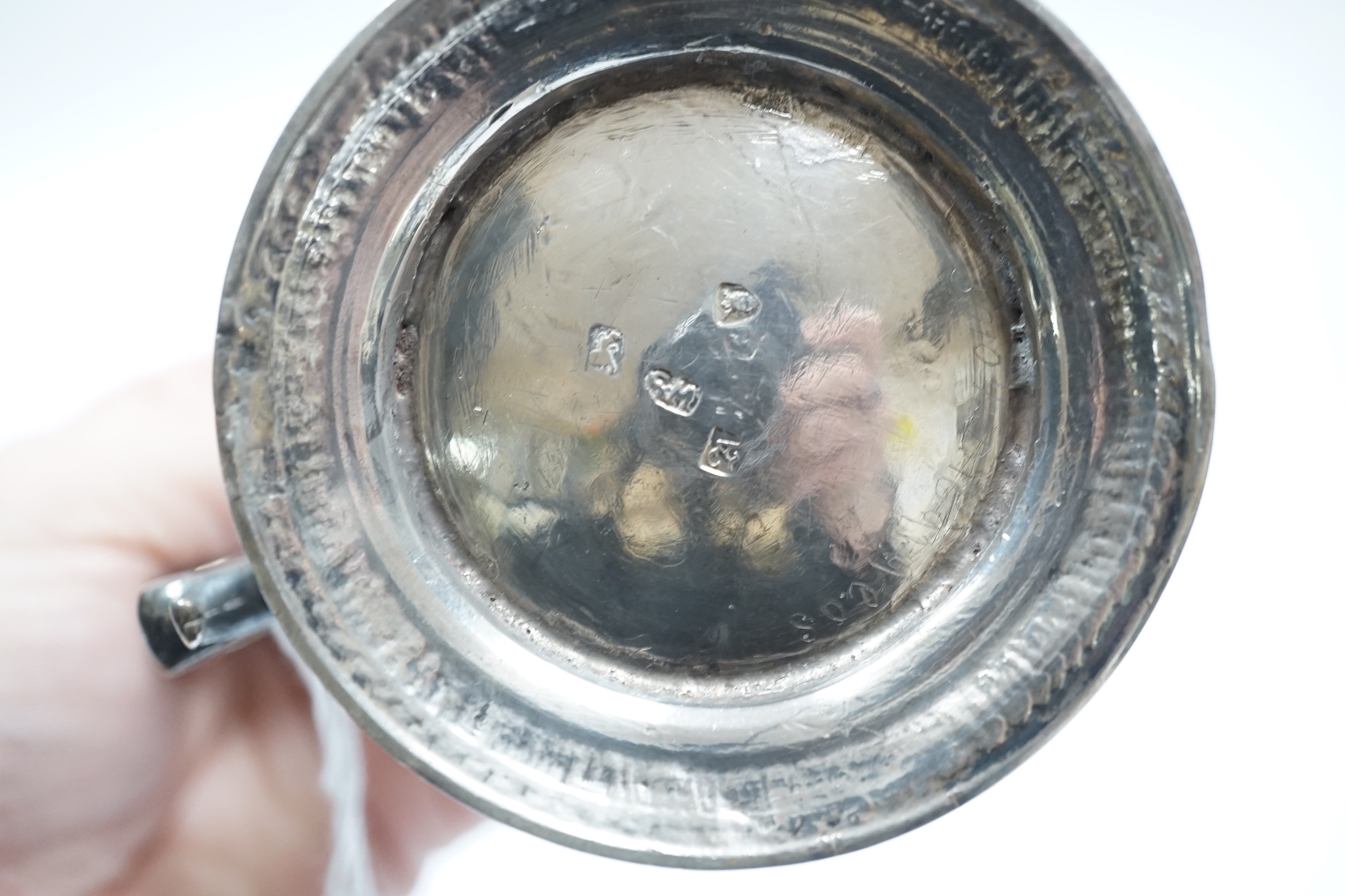 A late George II silver baluster mug, with later embossed decoration, William Shaw II?, London, 1756, 93mm, together with a George III reeded silver small christening mug, London, 1814.